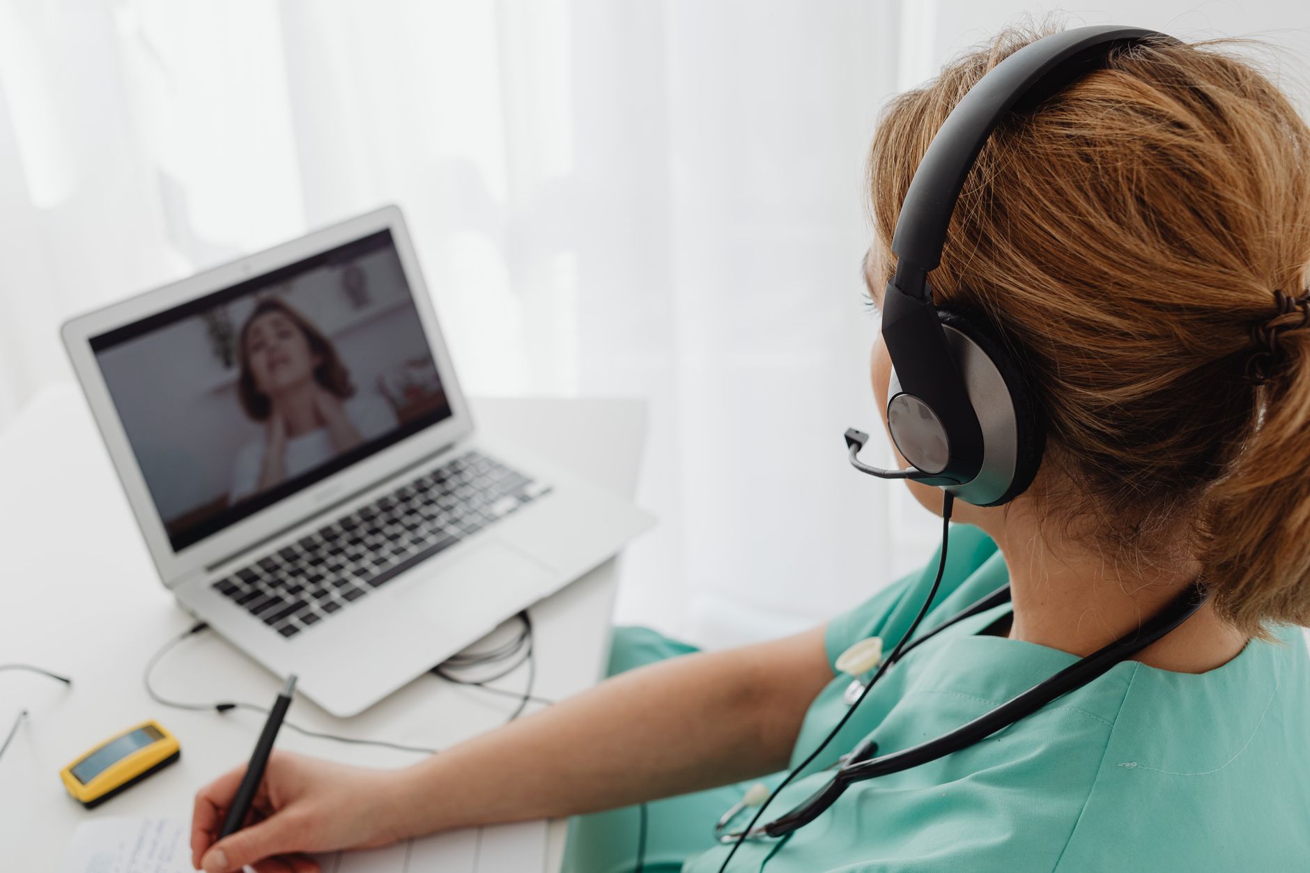 A clinician meeting a patient by video call from the clinic